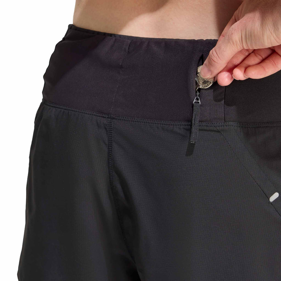Close-up view of the zip pocket on the back of the adidas Women's adi365 2in1 Short in the Black colourway.