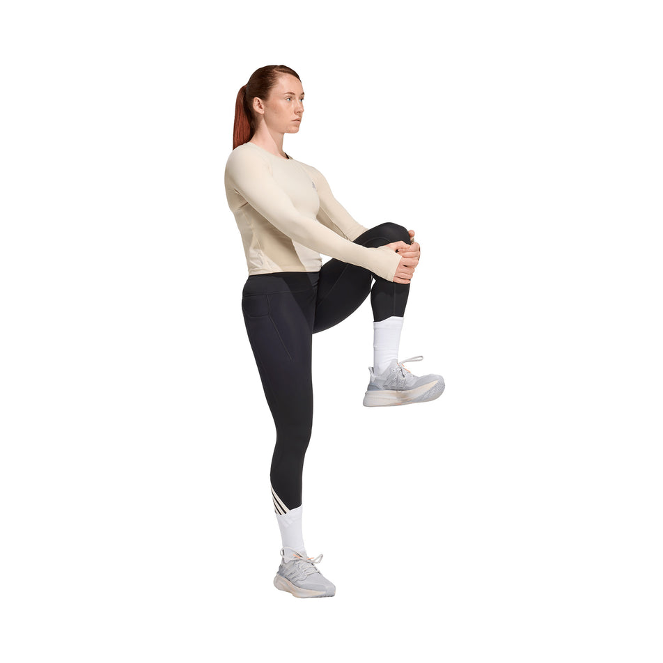 Angled view of a model wearing the adidas Women's adi365 3S 1/1 Tights in the Black colourway.