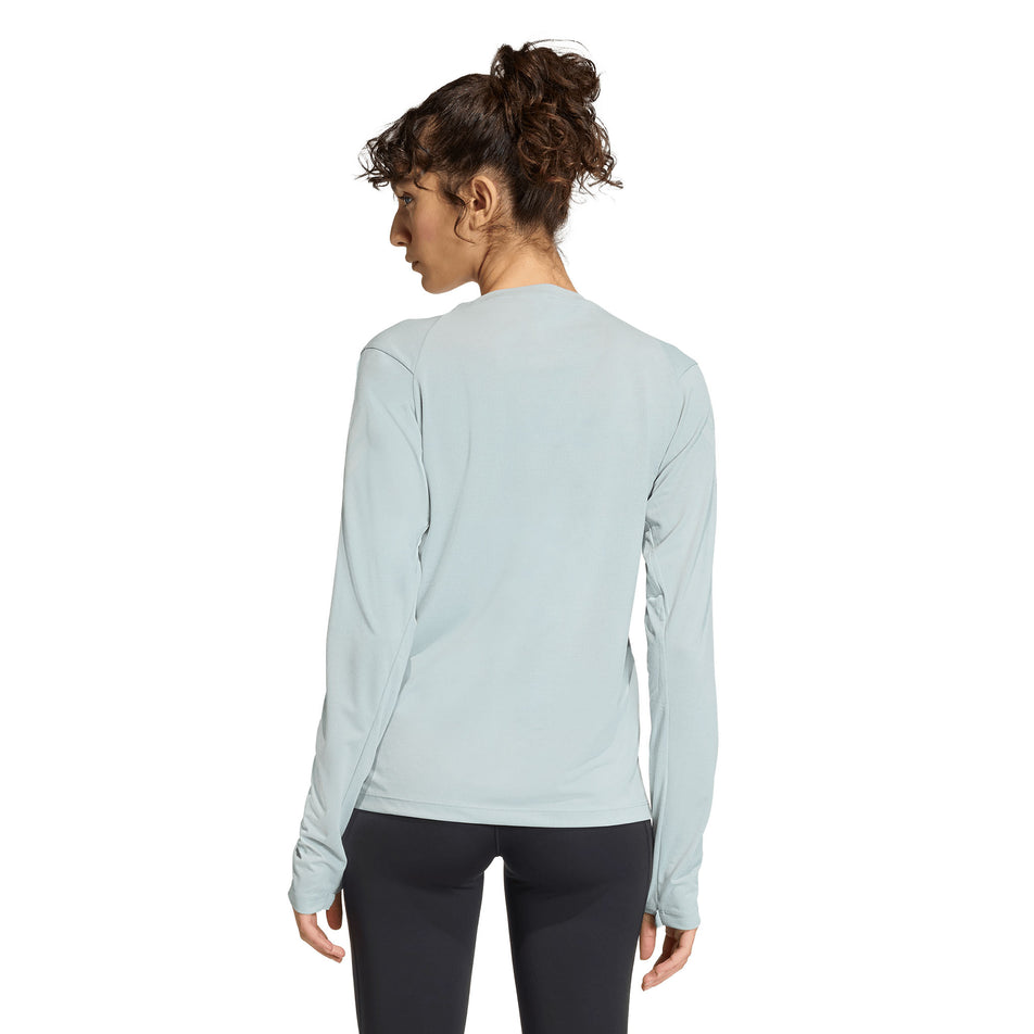 Back view of the model wearing the adidas Women's adi365 Long-Sleeve in the Wonder Sage colourway.