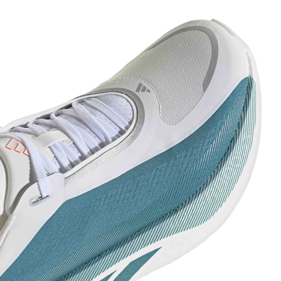 Close-up view of the toe box of the right shoe from a pair of adidas Men's Hyperboost Edge Running Shoes in the Ftwr White/Petrol Met./Lucid Red colourway.