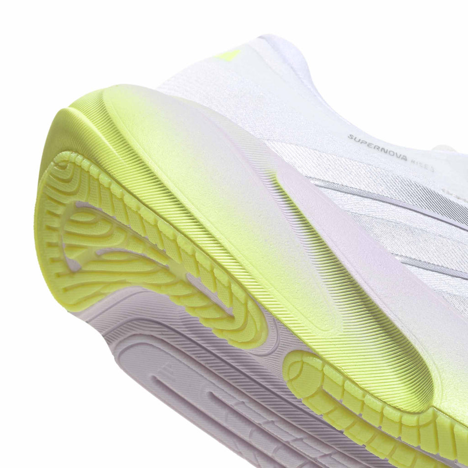 The rearfoot section of the right shoe from a pair of adidas Women's Supernova Rise 3 Running Shoes in the Crystal White/Silver Met./Purple Tint colourway.