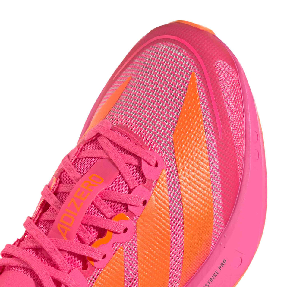 Close-up view of the toe box of the right shoe from a pair of adidas Women's Adizero Boston 13 Running Shoes in the Lucid Pink/Lucid Orange/Iron Met. colourway.