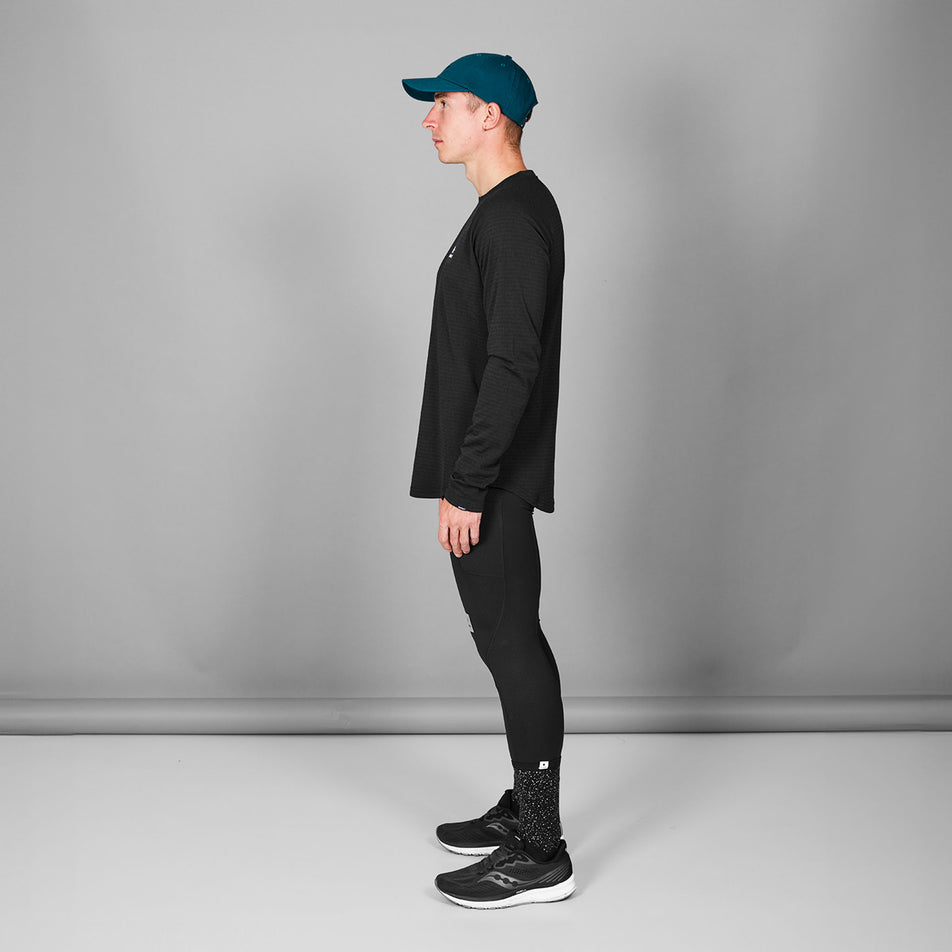 Side view of a model wearing the SAYSKY Men's Blaze Long Sleeve Light Fleece in the Black colourway. (8787584942242)