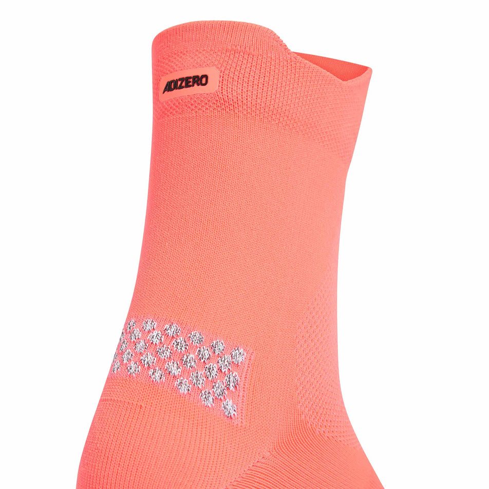 Close-up view of the back of a sock from a pair of adidas Unisex Run Adizero Quarter Running Socks in the Solar Turbo/Black colourway.