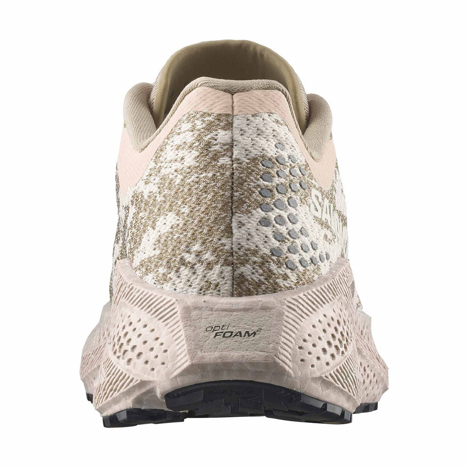 The back of the right shoe from a pair of Salomon Women's Aero Glide 4 GRVL Running Shoes in the Tapioca/Desert Tan colourway.