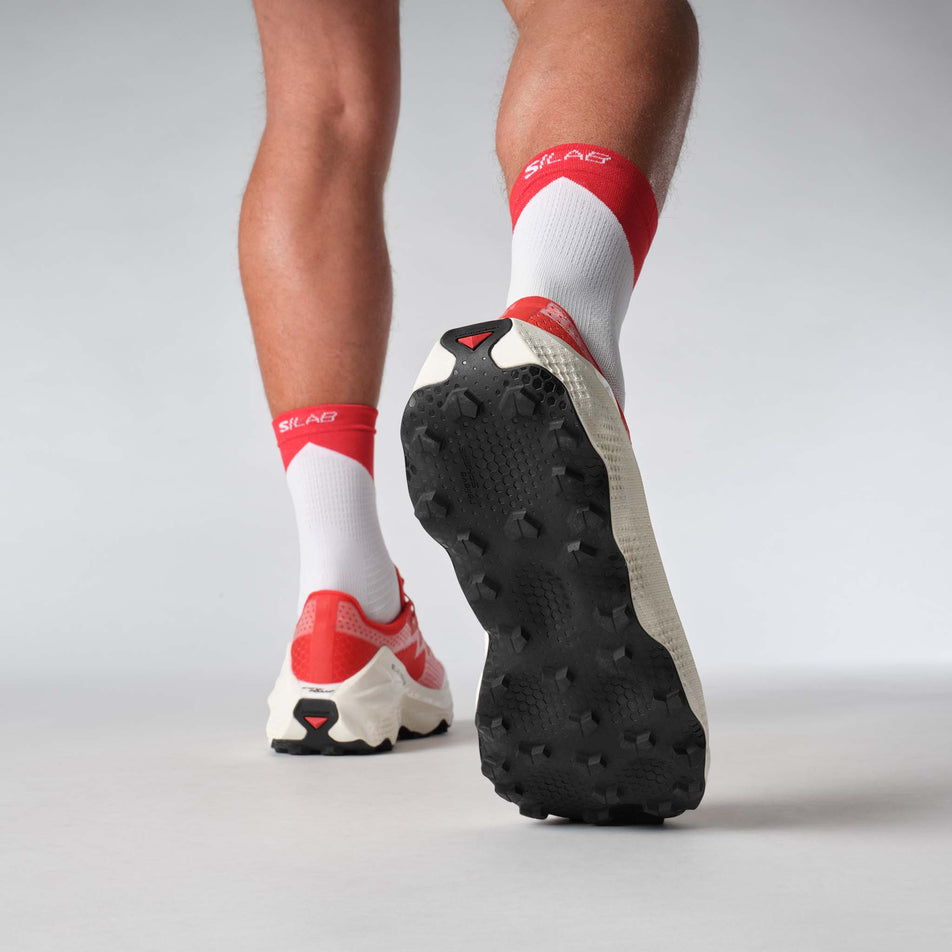 A model wearing a pair of Salomon Unisex S/LAB Ultra Glide Running Shoes in the Fiery Red colourway. (8576021921954)