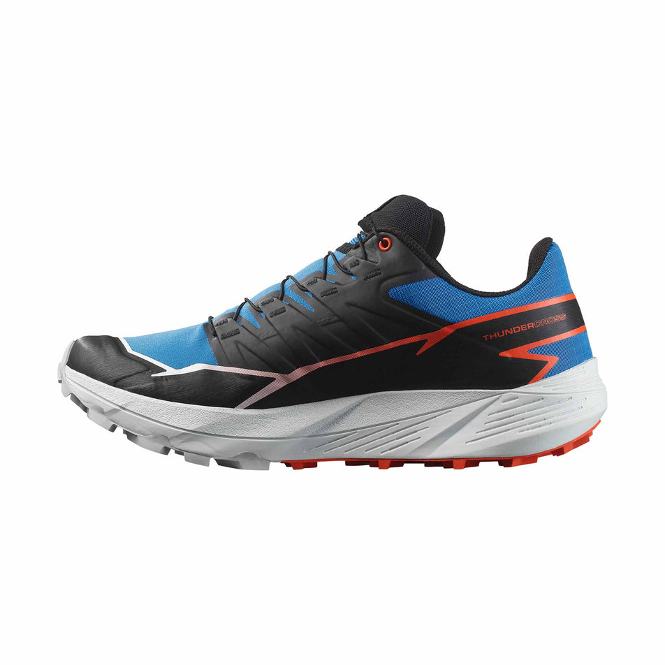 Medial side of the right shoe from a pair of Salomon Men's Thundercross Running Shoes in the French Blue/Black/Cherry Tomato colourway. (8560936288418)