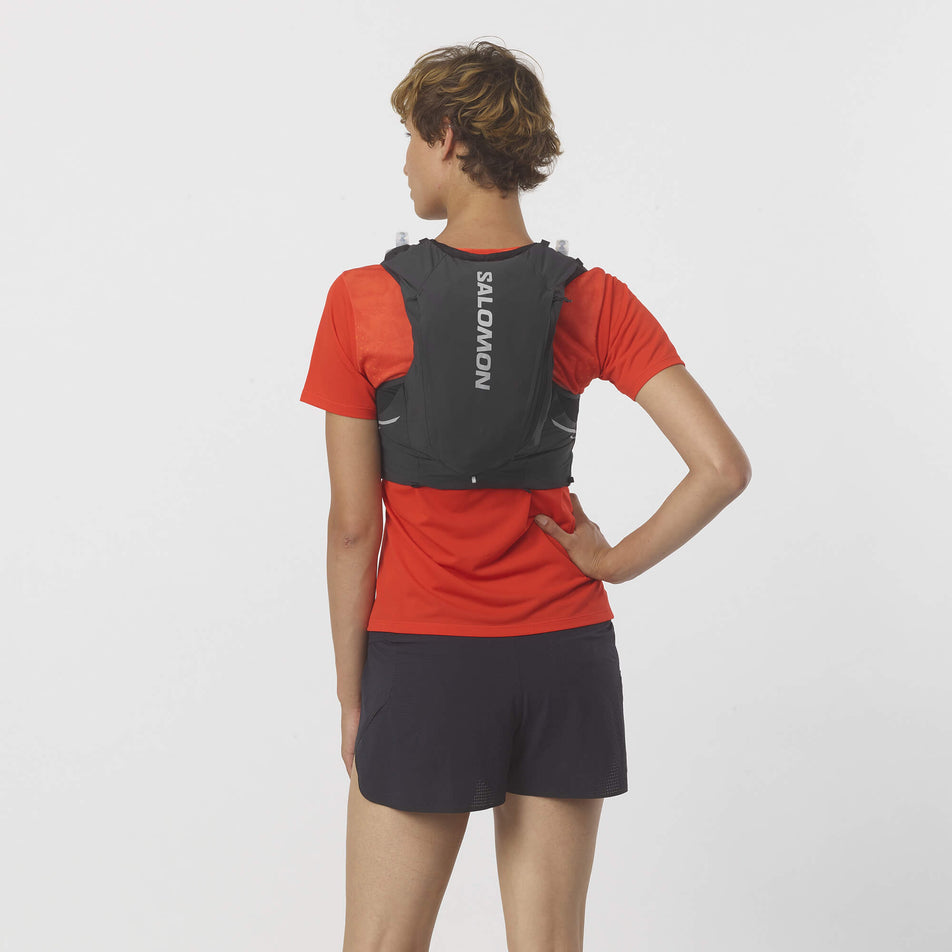 Back of a model wearing a Salomon Unisex Sense Pro 10 Running Vest in the Black/Ebony colourway, with flasks included. (7992933253282)