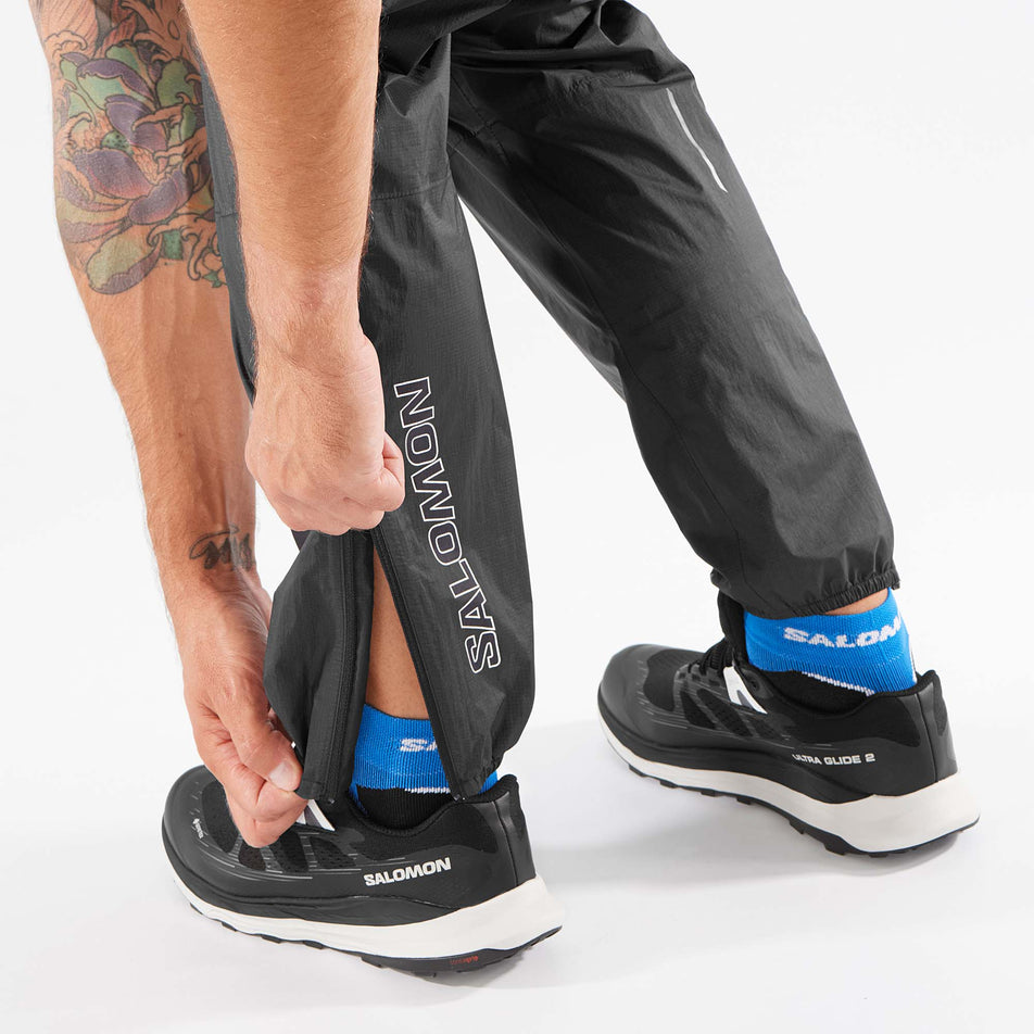 A model demonstrating an ankle zip on a pair of Salomon Unisex Bonatti Waterproof Pants (8071099220130)