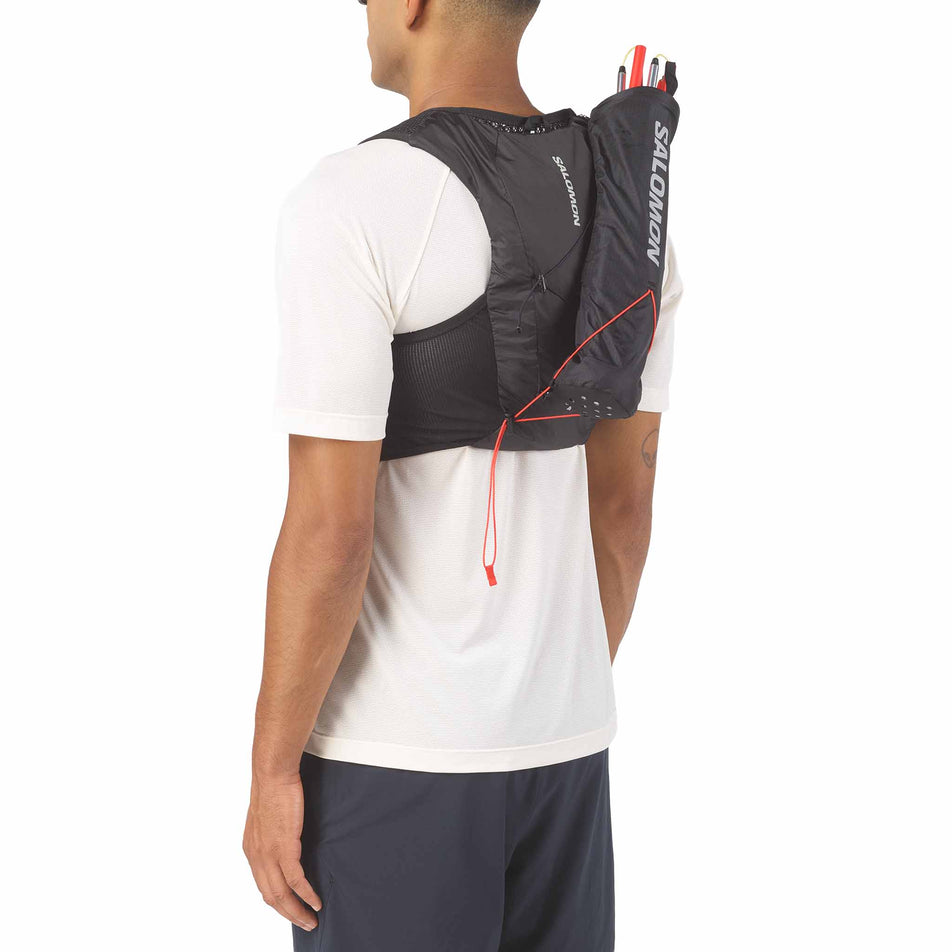 The Salomon Custom Quiver in the Black colourway attached to the back of a hydration vest.