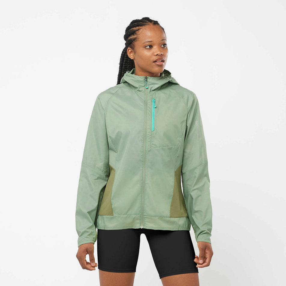 Front view of a model wearing a Salomon Women's Bonatti Cross Wind Jacket in the Lily Pad/Deep Lichen Green colourway (7999055462562)