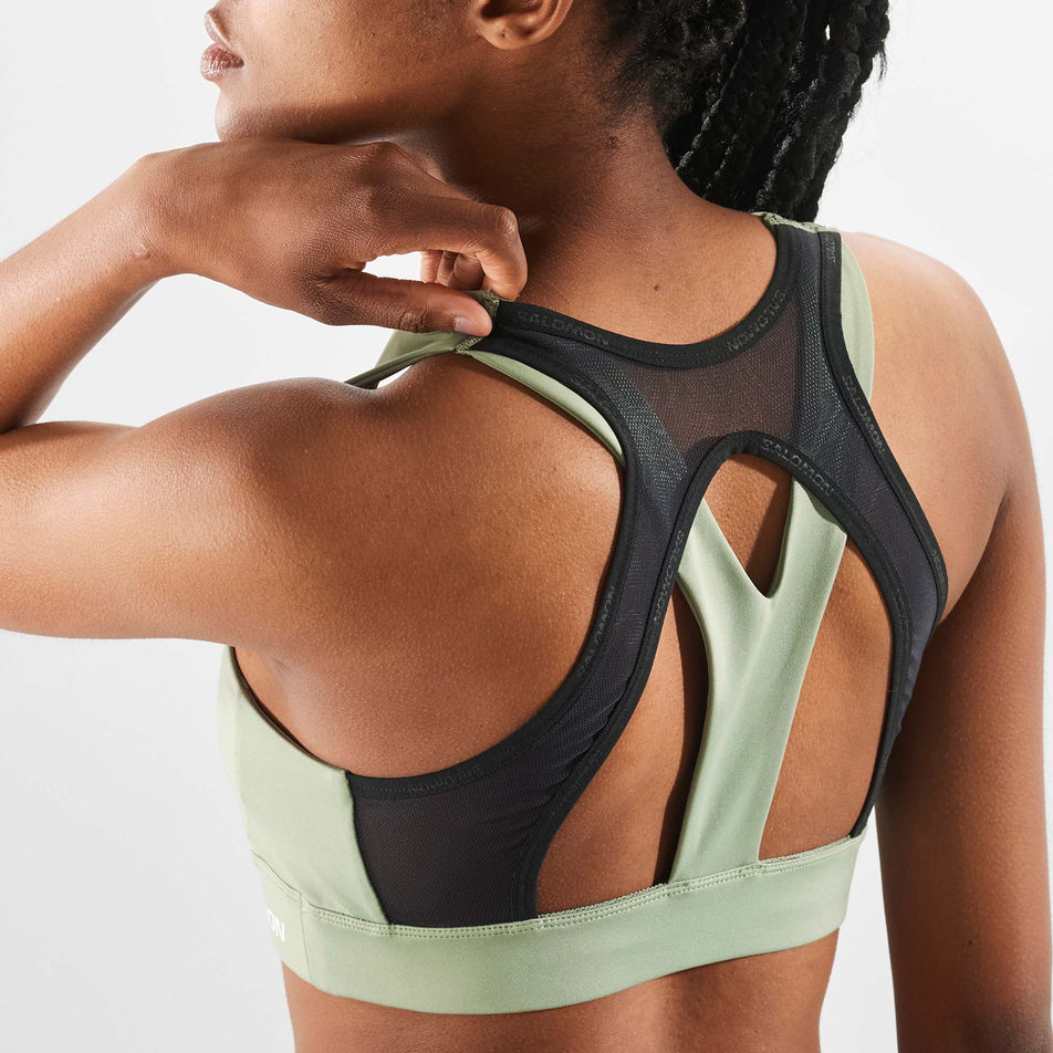 Close-up back view of a model wearing a Salomon Women's Cross  Run Bra in the Lily Pad colourway (7999430492322)