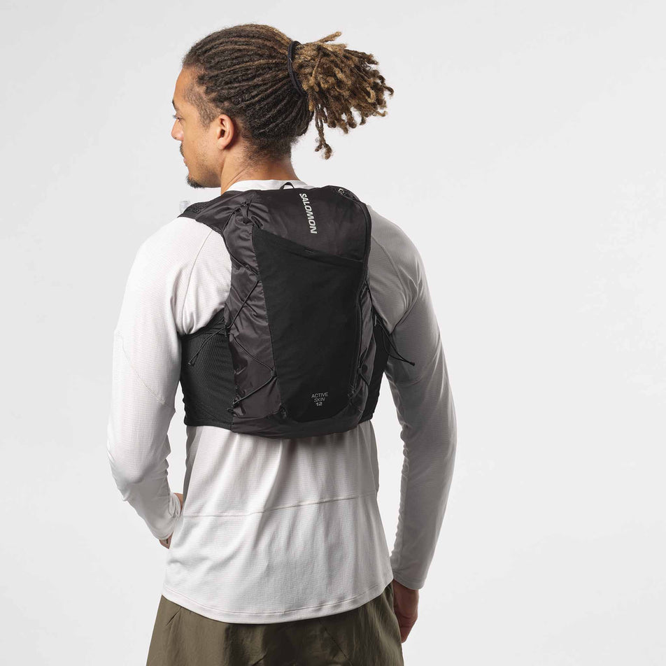 Back view of a model wearing a Salomon Unisex Active Skin 12 Set in the Black/Metal colourway. (8407345889442)