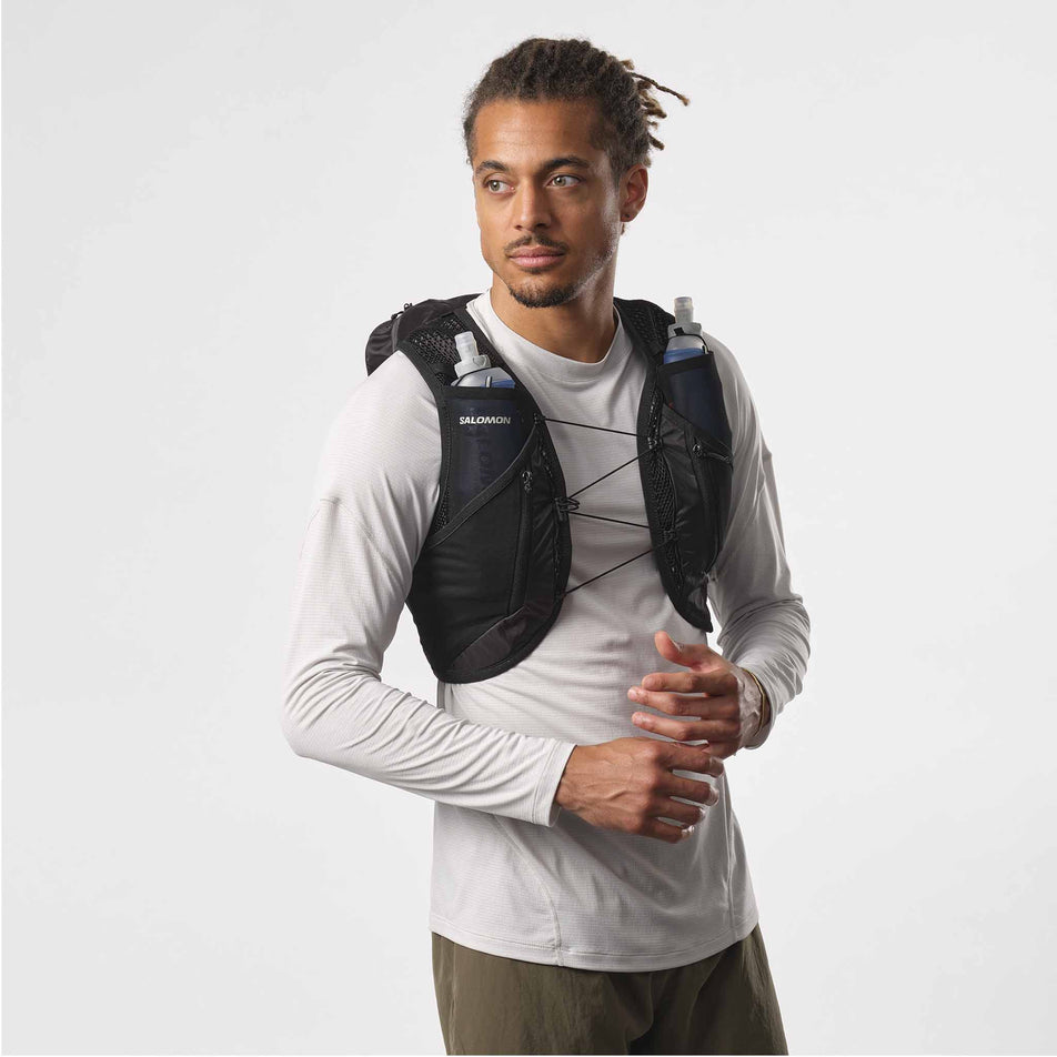 Front view of a model wearing a Salomon Unisex Active Skin 12 Set in the Black/Metal colourway. (8407345889442)