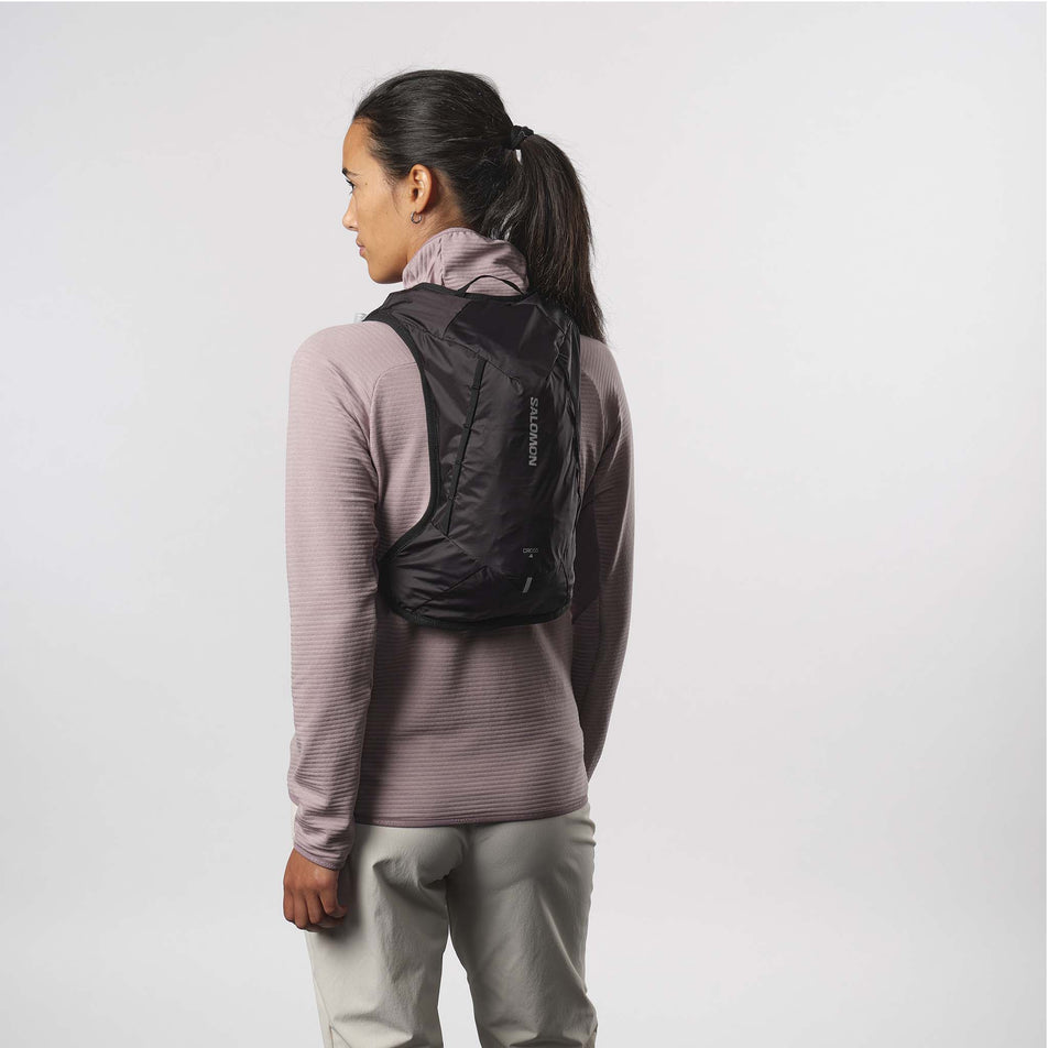 Back view of a model wearing a Salomon Unisex Cross 4 Rucksack in the Black colourway. (8407394123938)