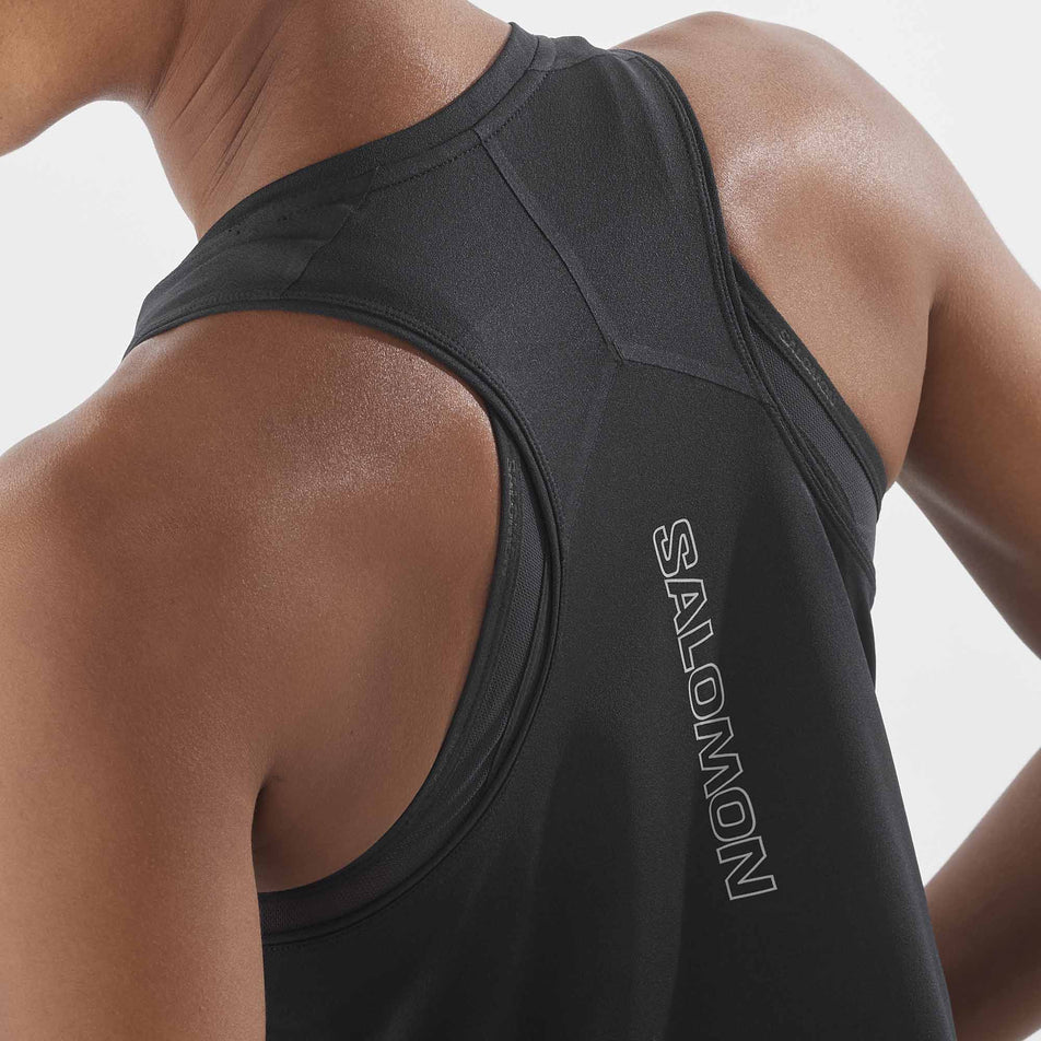Close-up back view of a model wearing a Salomon Women's Aero Short Tank in the Deep Black colourway.  (8311894966434)
