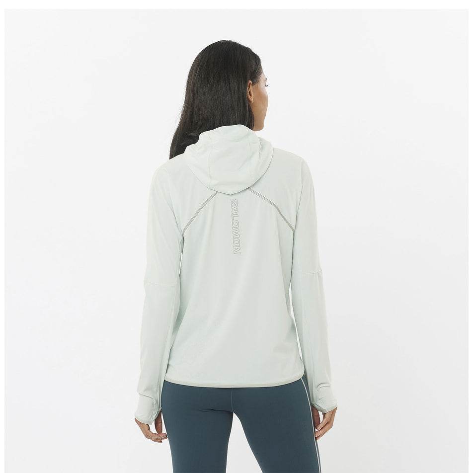 Back view of a model wearing a Salomon Women's Sense Aero Hybrid Half Zip Midlayer in the Misty Blue colourway. Model is also wearing Salomon leggings. (8463148417186)