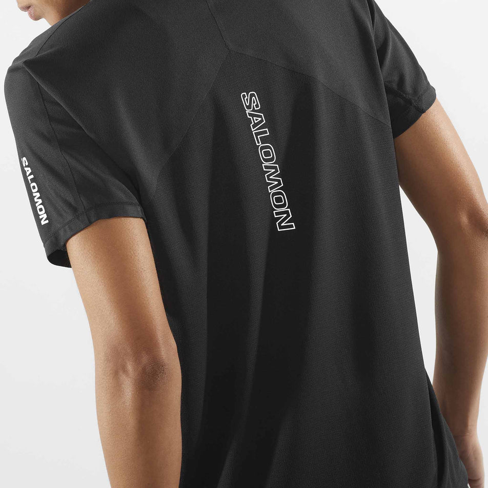 Close-up view of the back of a Salomon Women's Sense Aero Short Sleeve T-Shirt in the Deep Black colourway. Top is being worn by a model.  (8462977695906)