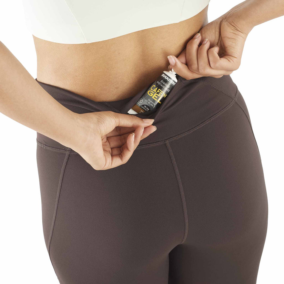 A model demonstrating the storage at the back of the Salomon Women's SHAKEout BLISS 25