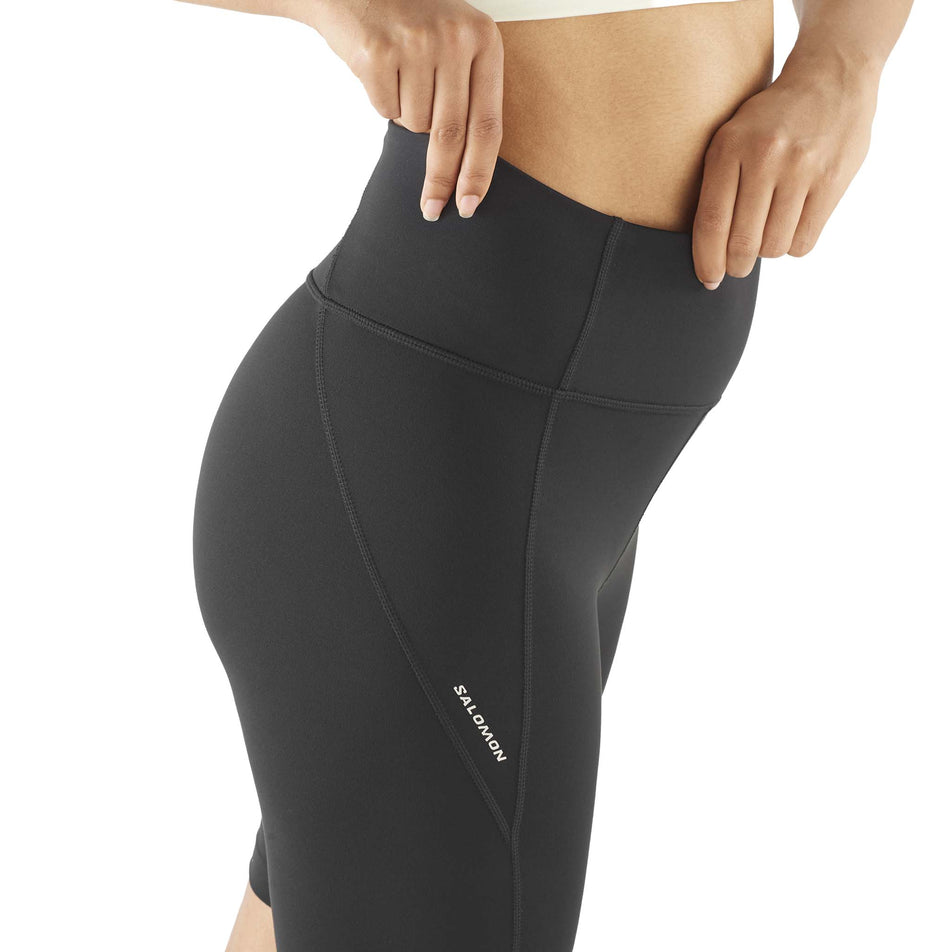 Side view of a model wearing the Salomon Women's SHAKEout BLISS 8