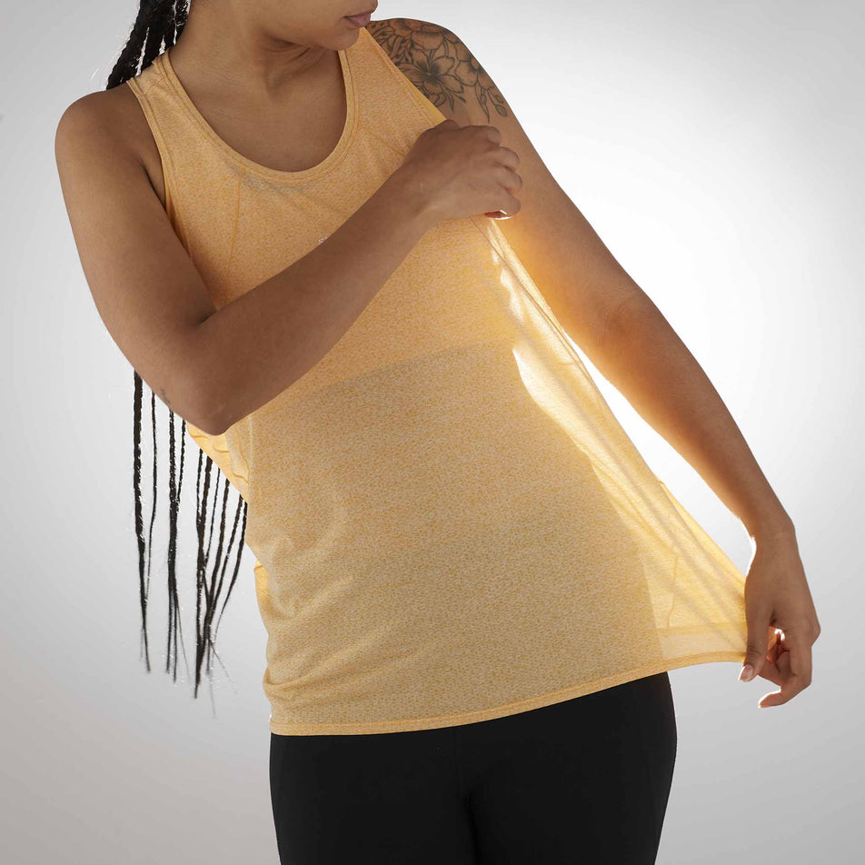 Front view of a model wearing the Salomon Women's SHKout Air Tank in the Warm Apricot colourway. (8577418297506)