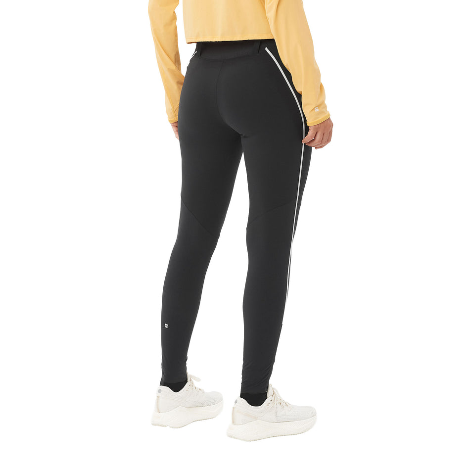 Back view of a model wearing the Salomon Women's Sense Aero Stow Tights in the Deep Black colourway. (8727044685986)