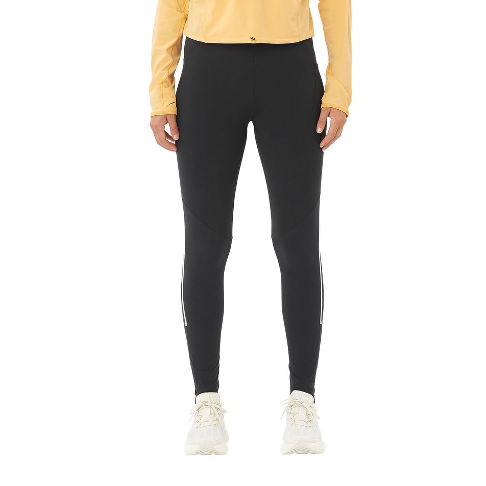 Front view of a model wearing the Salomon Women's Sense Aero Stow Tights in the Deep Black colourway. (8727044685986)