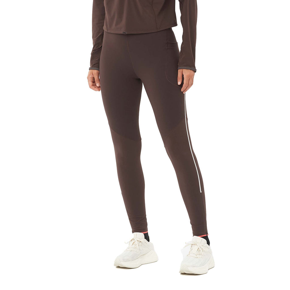 Front view of a model wearing the Salomon Women's Sense Aero Stow Tights in the Coffee Bean colourway. (8574546084002)