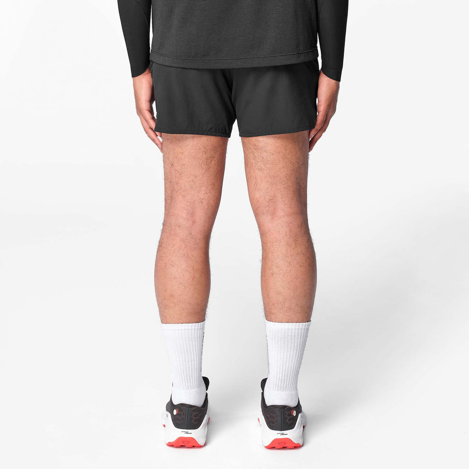 Back view of a model wearing the Salomon Men's Shakeout Core Shorts 5