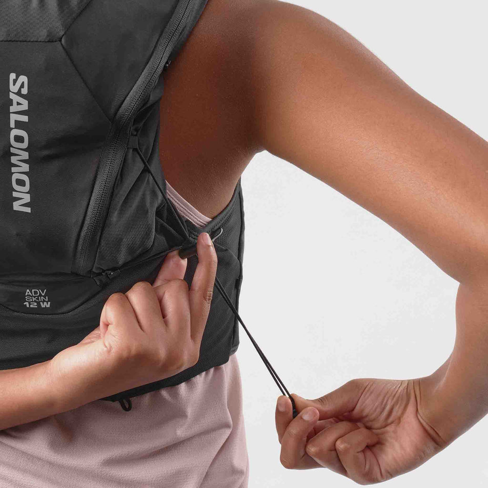 Back view of a model wearing the Salomon Women's ADV Skin 12 Set Running Vest in the Black/Asphalt colourway.