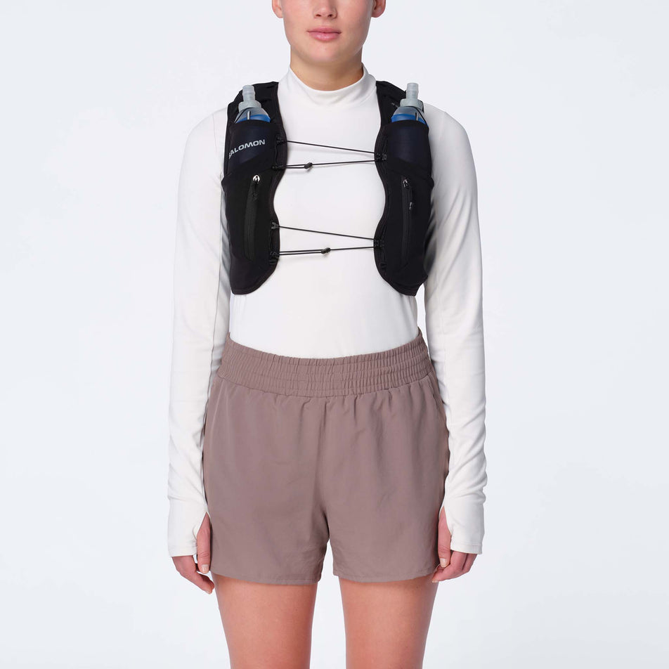 Front view of model wearing the Salomon Women's ADV Skin 12 Set Running Vest in the Black/Asphalt colourway.