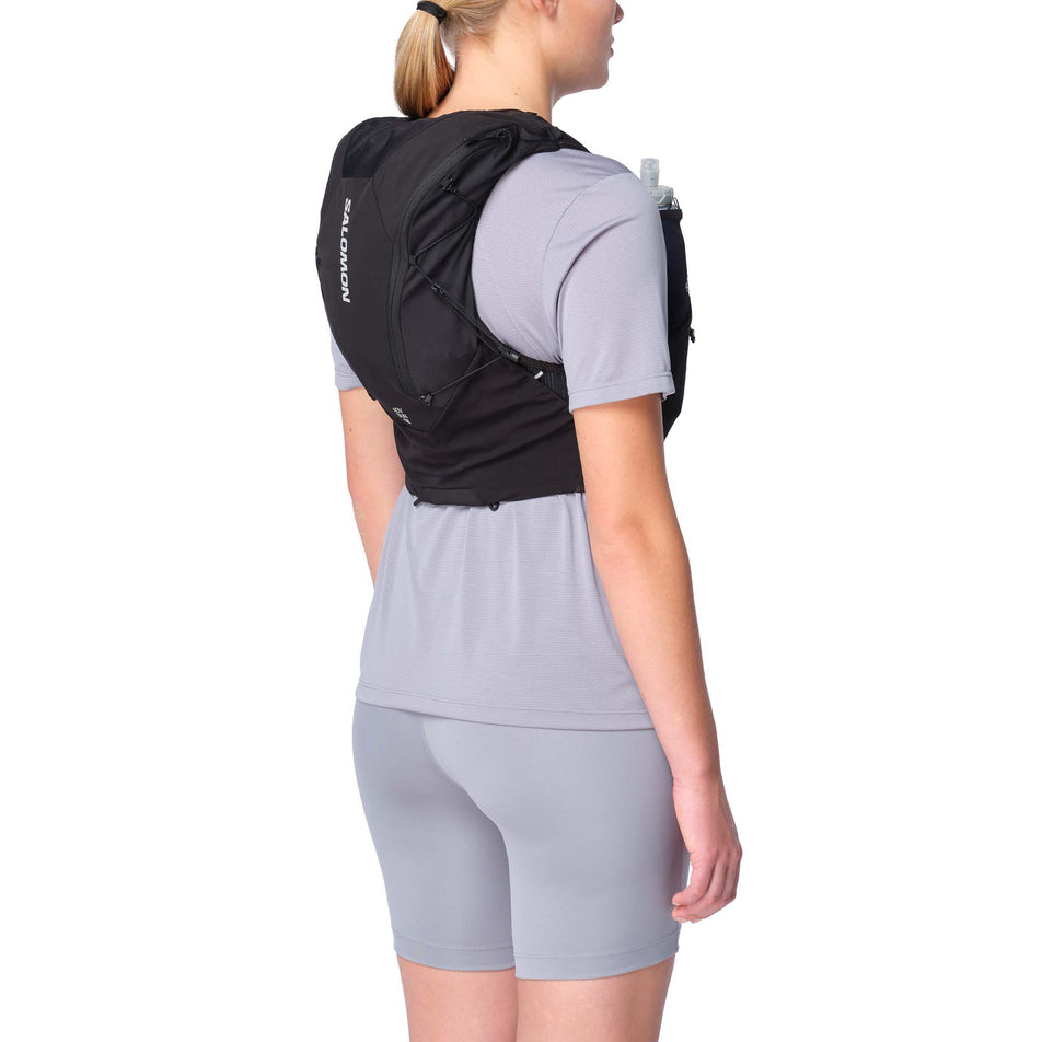 Angled view of a model wearing the Salomon Unisex ADV Skin 12 Running Vest in the Black colourway.