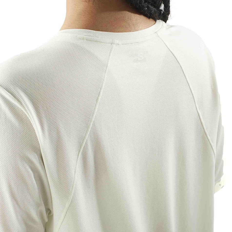Back view of a model wearing the Salomon Women's SHKout Core Short Sleeve T-Shirt in the Icicle colourway. (8575550980258)