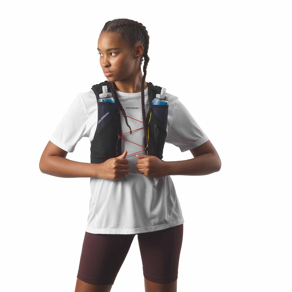 Front view of a model wearing the Salomon Unisex ADV Skin 5 Race Flag Running Vest with flasks included in the Black/White colourway. (8575896682658)