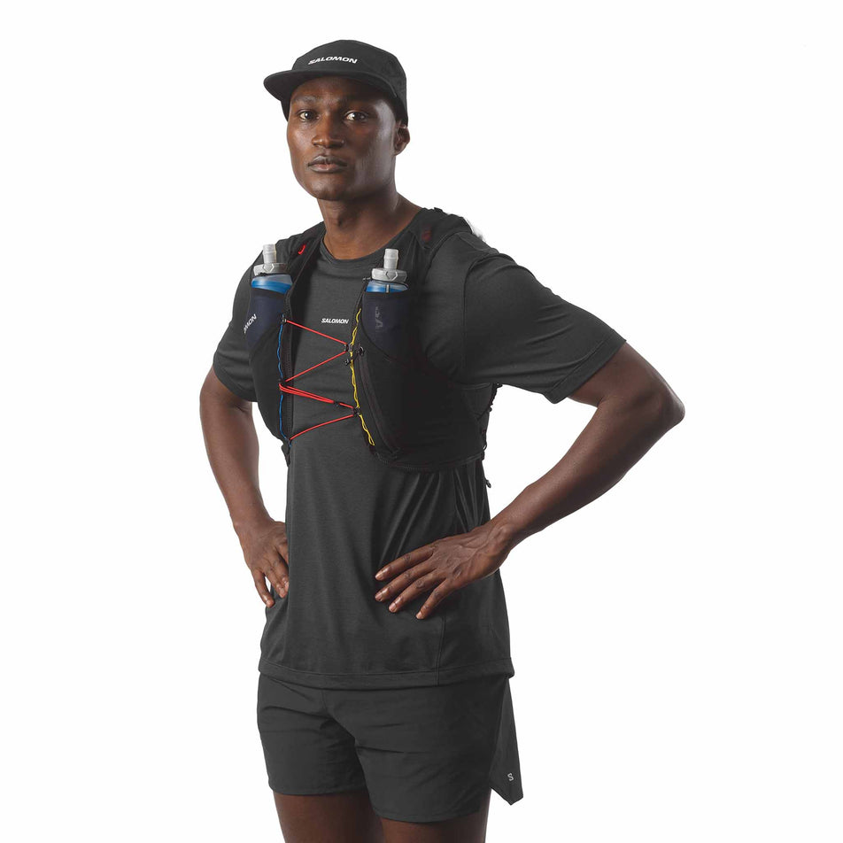 Front view of a model wearing the Salomon Unisex ADV Skin 5 Race Flag Running Vest with flasks included in the Black/White colourway. (8575896682658)