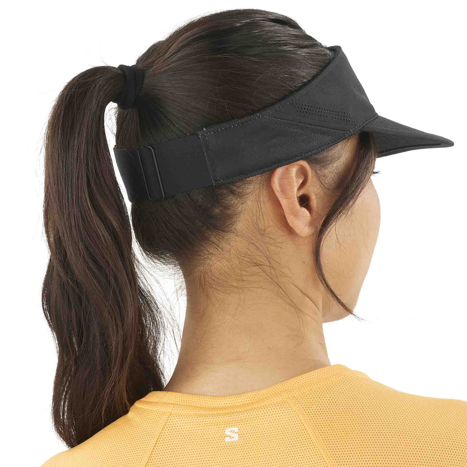 Back view of a model wearing the Salomon Unisex SHKout Visor in the Deep Black colourway. (8577894645922)
