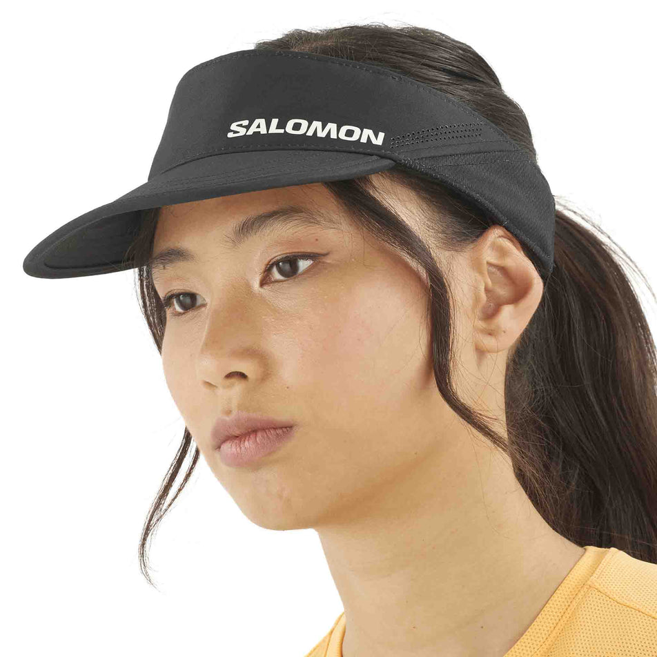 Front view of a model wearing the Salomon Unisex SHKout Visor in the Deep Black colourway. (8577894645922)