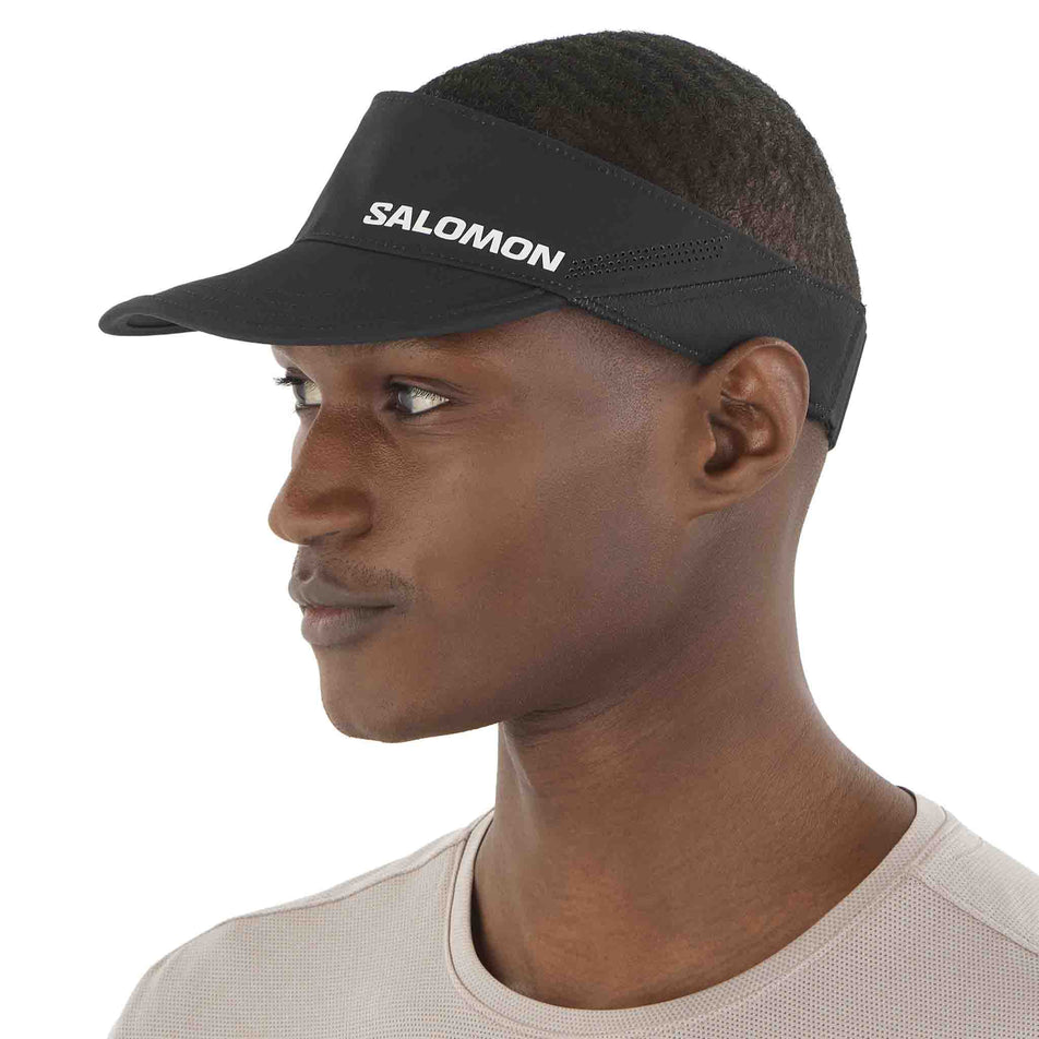 Front view of a model wearing the Salomon Unisex SHKout Visor in the Deep Black colourway. (8577894645922)