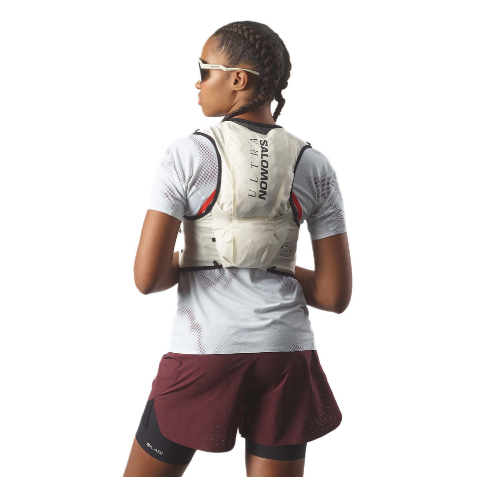 Back view of a model wearing the Salomon Unisex S/LAB Ultra 10 Running Vest with flasks included in the Vanilla Ice/Black colourway. (8575903006882)