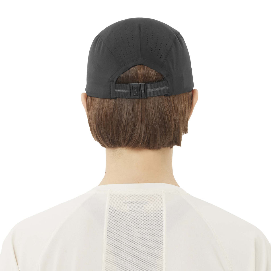 Back view of a model wearing the Salomon Unisex SHAKEout Cap in the Deep Black colourway. (8738175189154)