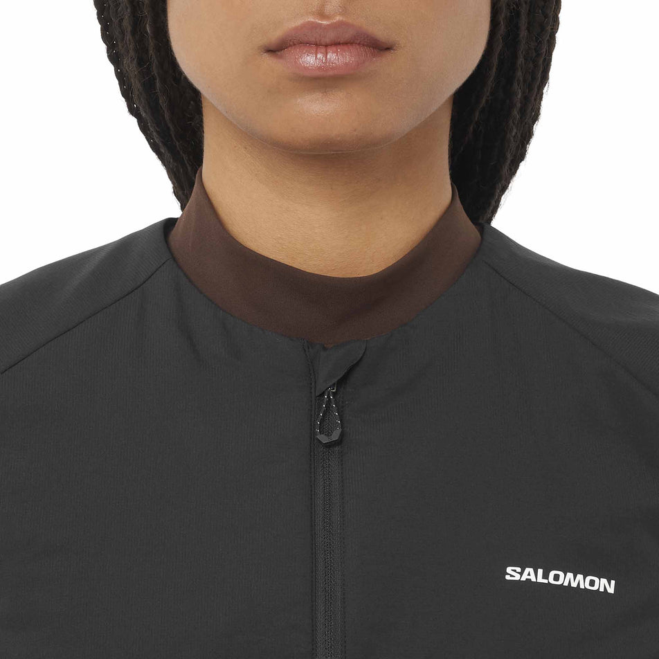 Front view of a model wearing the Salomon Women's Mountain Flex Hybrid Running Vest in the Deep Black colourway. (8781884653730)