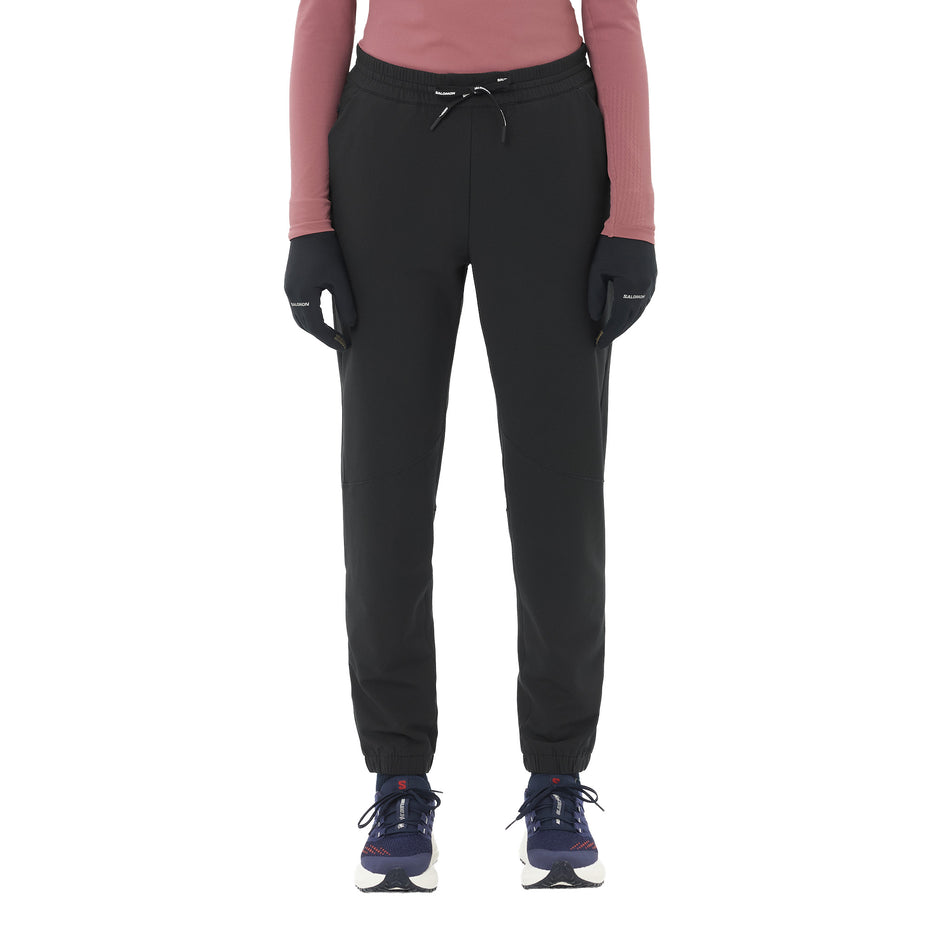 Front view of a model wearing the Salomon Women's SHAKEout HexaFlow Pants in the Deep Black colourway. (8781921091746)