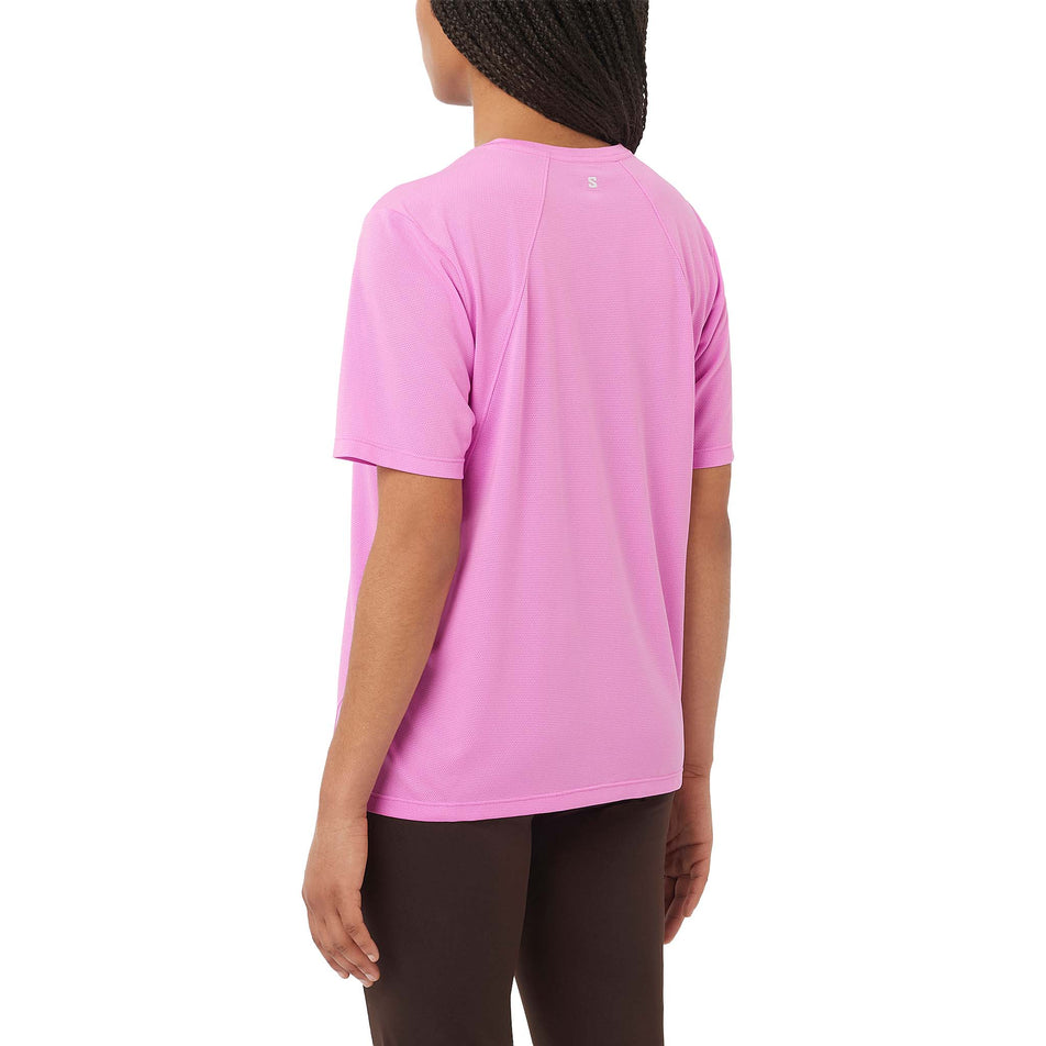 Back view of a model wearing the Salomon Women's SHAKEout CORE Short Sleeve T-Shirt in the Cyclamen colourway. (8730445840546)