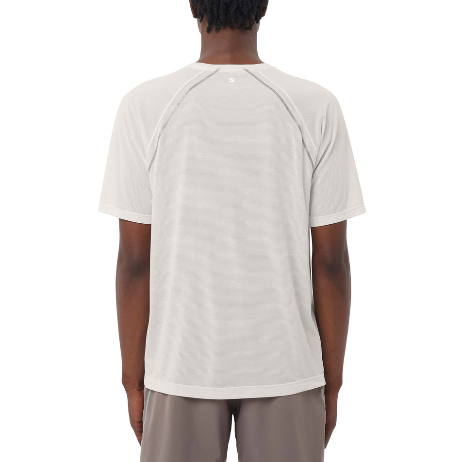 Back view of a model wearing the Salomon Men's SHAKEout CORE Stellar Short-Sleeve T-Shirt in the Whisper White colourway. (8736832192674)
