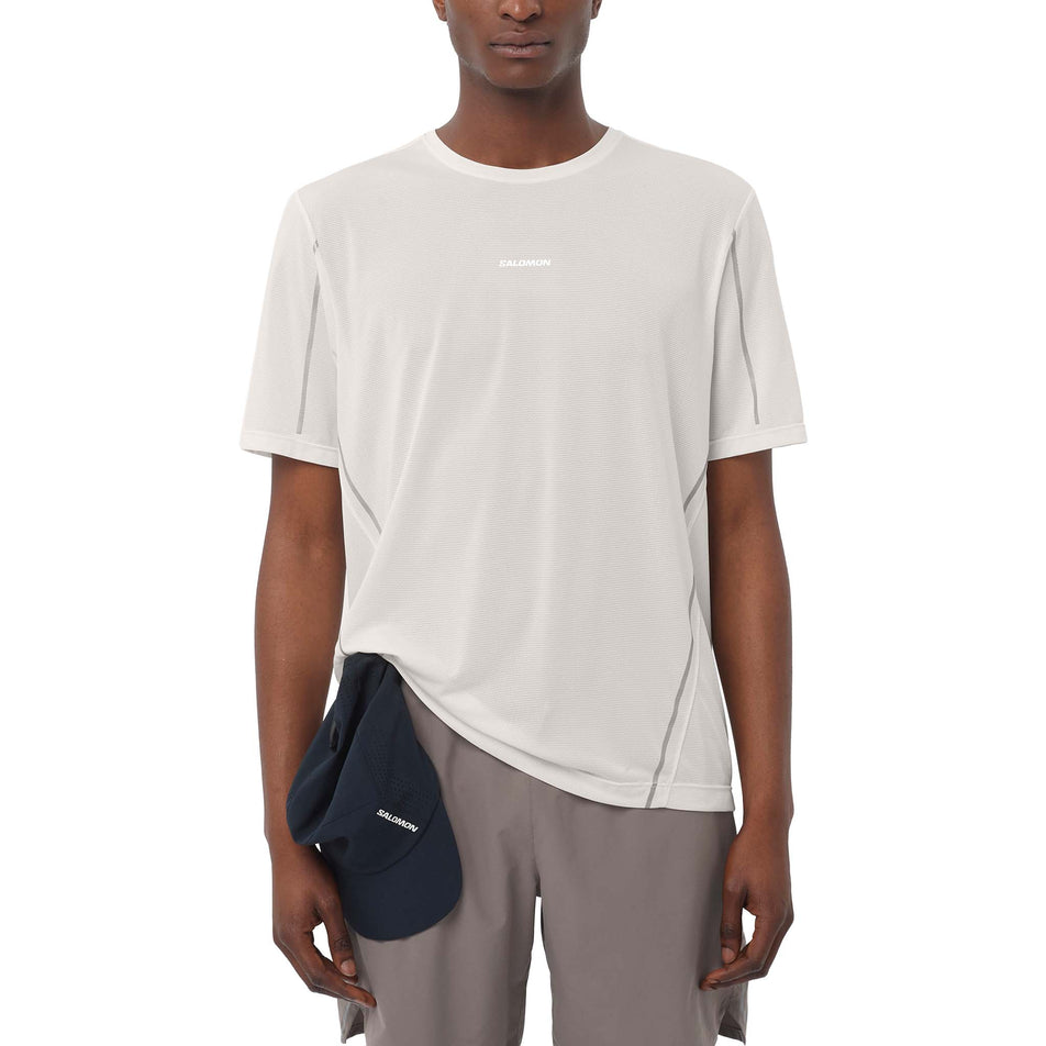 Front view of a model wearing the Salomon Men's SHAKEout CORE Stellar Short-Sleeve T-Shirt in the Whisper White colourway. (8736832192674)