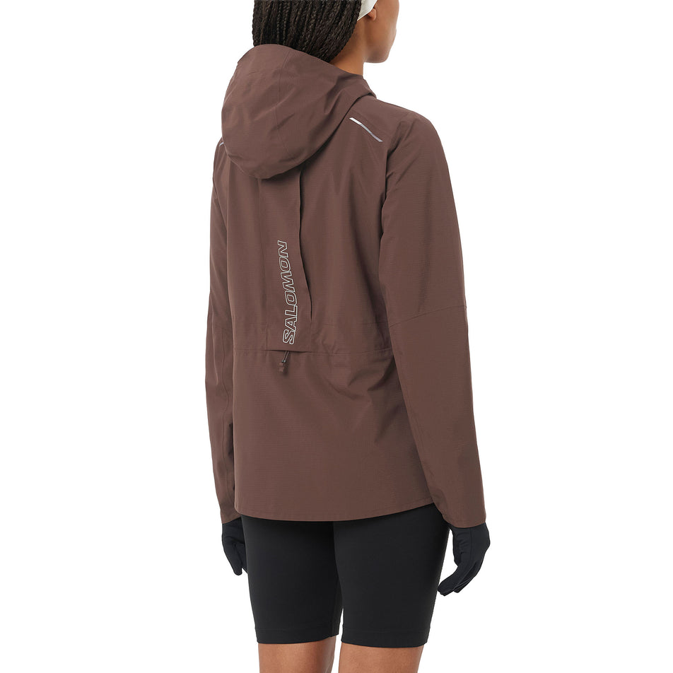 Back view of a model wearing the Salomon Women's Bonatti Trail Shell Jacket in the Coffee Bean colourway. (8726944186530)