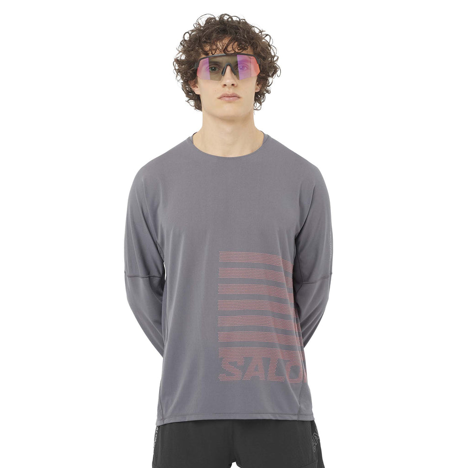 Front view of a model wearing the Salomon Men's Sense Aero Graphic Long Sleeve T-Shirt in the Castlerock/Neon Flame colourway. (8577952907426)