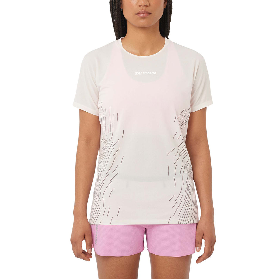 Front view of a model wearing the Salomon Women's Sense Aero Graphic Short Sleeve T-Shirt in the Whisper White/White colourway. (8727016571042)