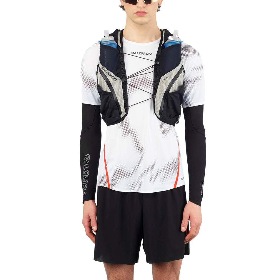 Front view of a model wearing the Salomon Unisex S/LAB Adventure 20 Running Vest with flasks included in the Black/White colourway. (8737335279778)