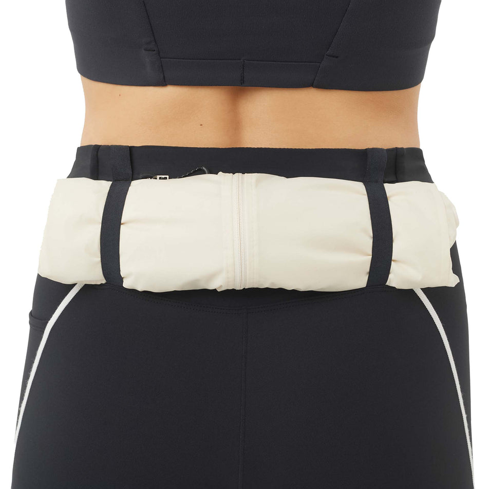 A jacket stored in the storage loops on the back of the Salomon Women's Sense Stow Short Tights 6